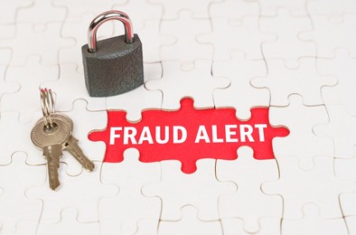 business and security concept. on puzzles there is a lock and keys, on a red surface there is an inscription - fraud alert