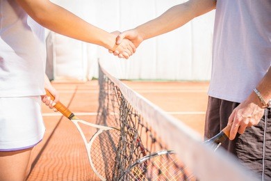handshake at tennis court - agonism,respect,fair play,sport concept