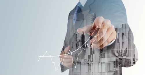 double exposure of businessman hand working with new modern computer and business strategy as concept 