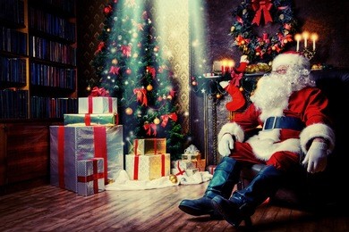 santa claus brought gifts for christmas and having a rest by the fireplace. home decoration.