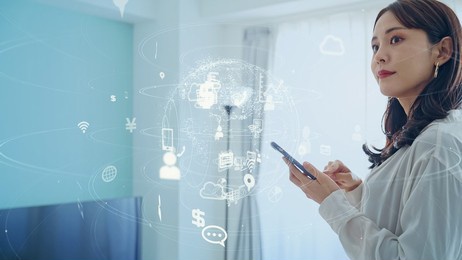 asian woman operating smart home appliances on smartphone. smart house. home automation. 