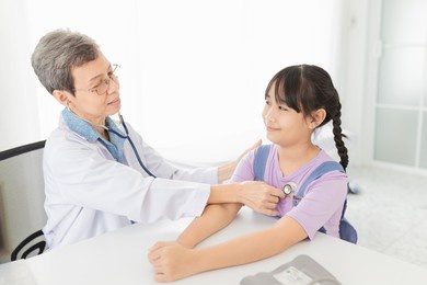 close up doctor, asian doctor talk with children patient about disease symptom, doctor use stethoscope listening lung of patient, children health check up, happiness hospital