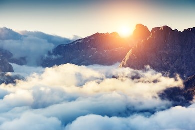 great view of the foggy val di fassa valley with passo sella. national park. dolomites, south tyrol. location canazei, campitello, mazzin. italy, europe. dramatic scene. beauty world.
