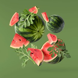 fresh raw watermelon falling in the air isolated on green background. food levitation or zero gravity conception. igh resolution image.