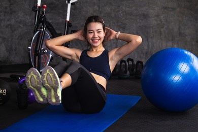 woman exercise sit-up workout building sixpack abs at fitness gym training for healthy lifestyle strong on the floor sport people concept.