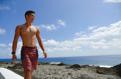man walking by the sea at sunset outdoors
