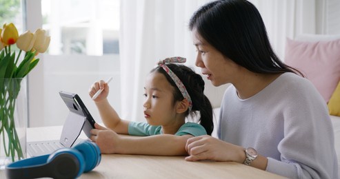 asia people young student alpha gen z girl fun play coloring on screen design idea art on home school online upskill class app help by mom. smart kid happy leisure indoor activity sit at table sofa.