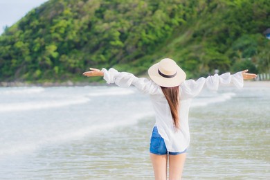 portrait beautiful young asian woman relax smile around beach sea ocean in holiday vacation travel trip