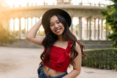 asian traveler woman with hat in european city at sunset