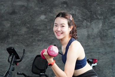 asian girl in leggings, dumbbells, at the gym, sport, fitness lifestyle, burning energy, healthy concept. exercise