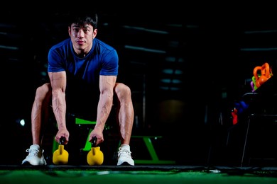 asian man exercising, in the gym, dumbbells, sport, lifestyle, fitness, energy burning, wellness concept. health care