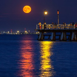 full moon in july at the pier in gdynia orlowo. poland