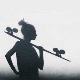 beautiful and fashion young woman posing with a longboard. photo of shadows of girl with a skateboard. square