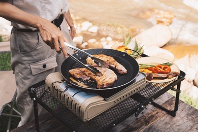 close up grilling barbecue in the campground at summer camp travel, skewers of pork and beef fillet on barbecue party in camping, summer camp travel one activity for relaxing..