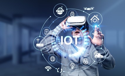 young man in vr headset finger touch virtual screen with internet of things hud, connection and network hud. concept of modern technology and interface