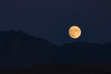 the moon rises above kingman, arizona.