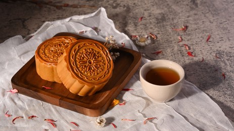 mid autumn festival mooncake and cup of tea on stone table