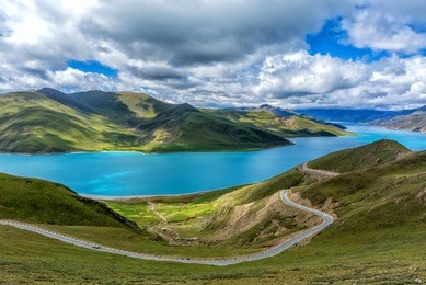 the yamdrok lake under the sunny blue sky in tibet of china.