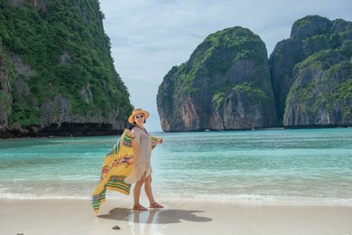 ํyoung asian women enjoy walking on the beach in maya bay located in phiphi island, krabi province.