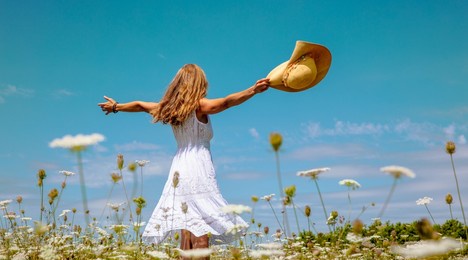 woman with white dress dancing in flower