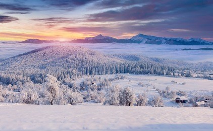 panorama of the foggy winter sunrise in the mountain village