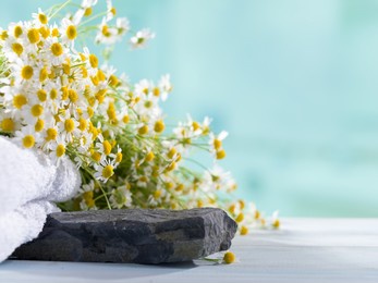 small stones and daisies on the table for product display. background for natural cosmetic products. selective focus 