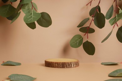 wood podium with green leaves and natural stones. abstract podium for organic cosmetic products. natural stand for presentation and exhibitions. 