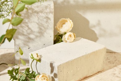 romantic background with concrete podium and flower for product presentation. spa product mockup. mock up for cosmetics with concrete background and stone podium.  light pink background