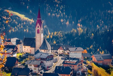 astonishing autumn view of  pfarrei maria vom guten rat christian church, italy, europe. spectacular morning scene of dolomite alps. traveling concept background.