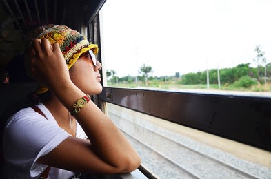 travelers thai women people sitting on railway for journey explorer and portrait posing for take photo at window train go to destination travel visit phra nakhon si ayutthaya from bangkok, thailand