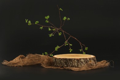 eco rustic wood stump disc platform podium, canvas fabric on black background. minimal empty display product presentation scene.
