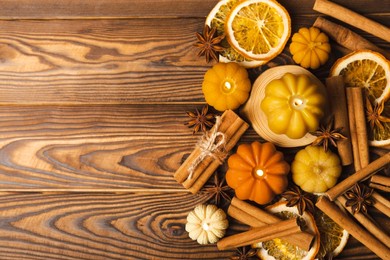 autumn composition.pumpkin candles,spicy star anise spices and cinnamon on a brown wooden background.cozy home decor.halloween concept.happy thanksgiving.flat lay.copy space.