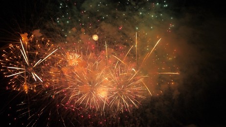 4k. bright new year's fireworks 2023. beautiful new year's eve. glowing loop christmas bokeh. holiday day christmas. beautiful bright color spot show. eve new year's holiday. national festival sky