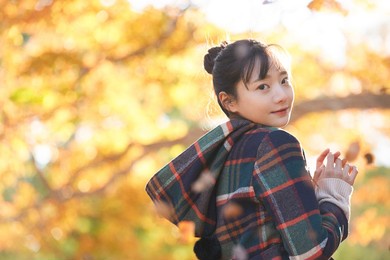 portrait of a young asian woman with autumn leaves