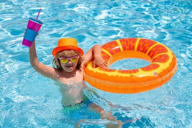 summer kids cocktail. kid boy swimming in pool play with floating ring. smiling cute kid in sunglasses swim with inflatable rings in pool in summer day. child relax with pool ring in beach sea water.