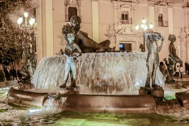 touristic landmarks of valencia - turia fountain on plaza de la virgen in front of metropolitan cathedral-basilica of the assumption of our lady of valencia. spain.