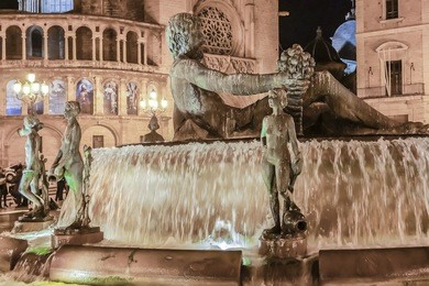 touristic landmarks of valencia - turia fountain on plaza de la virgen in front of metropolitan cathedral-basilica of the assumption of our lady of valencia. spain.