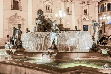 touristic landmarks of valencia - turia fountain on plaza de la virgen in front of metropolitan cathedral-basilica of the assumption of our lady of valencia. spain.