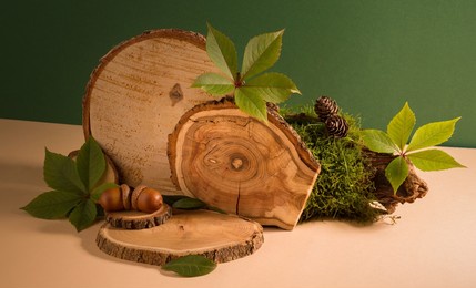 set of wooden podiums, decor and autumn leaves against beige and green background. good for perfume, jew or cosmetic product presentation.
