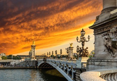 fantastic  sunset over alexandre iii bridge (pont alexandre iii) and the national residence of the invalids, paris, france