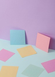 modern and creative composition with colored memo papers on two tone pastel background. minimal still life. business concept
