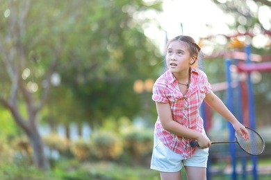 cute little girl playing badminton 