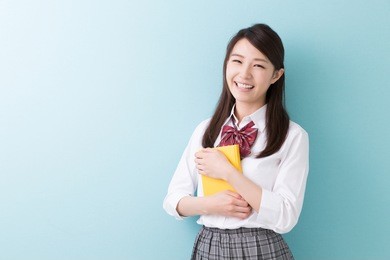 beautiful young asian school girl who reads a book