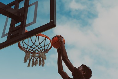 young african american man playing basketball outdoor - urban sport lifestyle concept