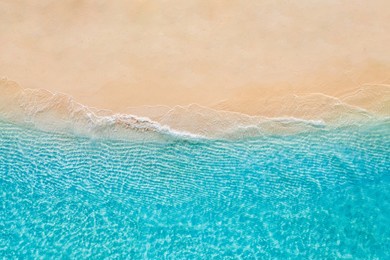 summer seascape beautiful waves, blue sea water in sunny day. top view from drone. sea aerial view, amazing tropical nature background. beautiful bright sea waves splashing and beach sand sunset light