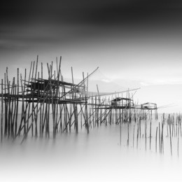 long exposure and black and white image of "langgai"  , the traditional fishing medium at malaysia .