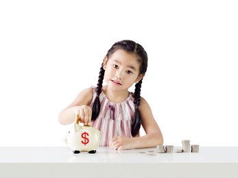 little girl thinking about saving putting money on a piggy bank.isolated on white background