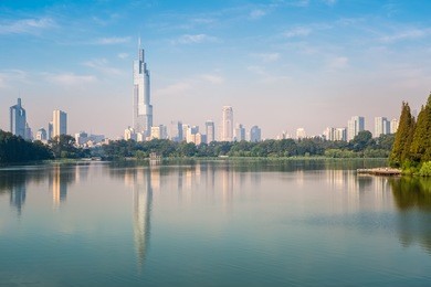 modern city building reflected in beautiful nanjing xuanwu lake