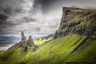 view of the storr and iconic old man of storr with dramatic cloudy sky. isle of skye, scottish highlands.