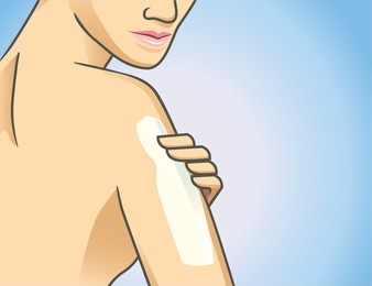 focus shot of woman applying lotion on arm